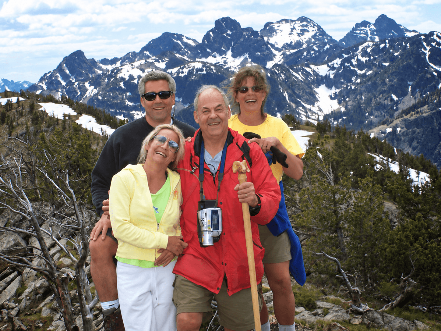 Jack and family smiling together on a snowy mountain hike